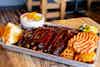 a tray of ribs and fries