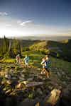 a group of people hiking on a rocky hill